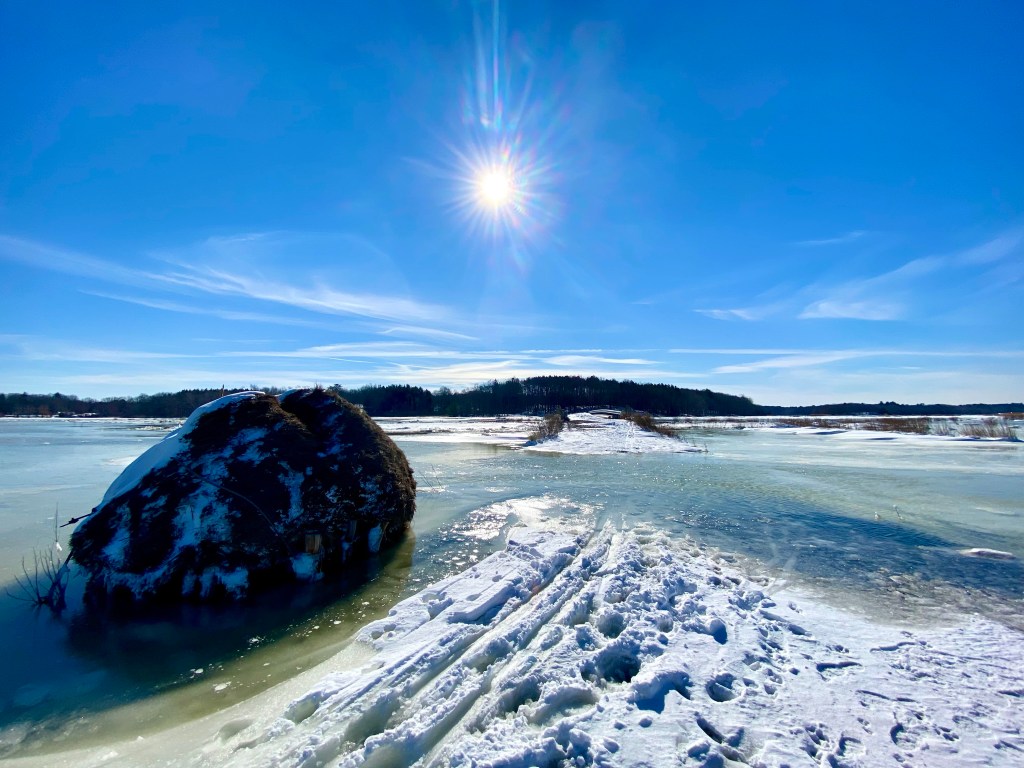 Bridge and large bail of hay in winter